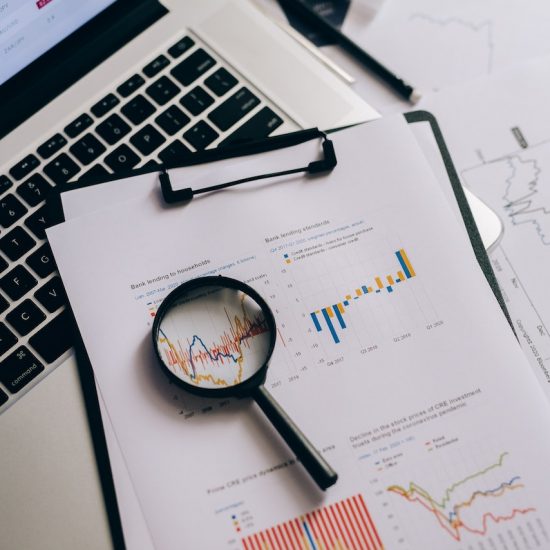 Magnifying glass on paper with data